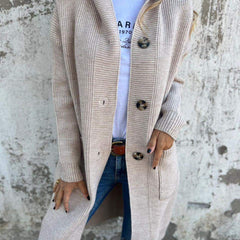 Woman wearing a long ribbed knit cardigan with large buttons and front pockets