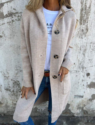 Woman wearing a long ribbed knit cardigan with large buttons and front pockets