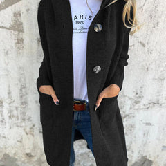 Woman wearing a long ribbed knit cardigan with large buttons and front pockets