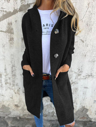 Woman wearing a long ribbed knit cardigan with large buttons and front pockets