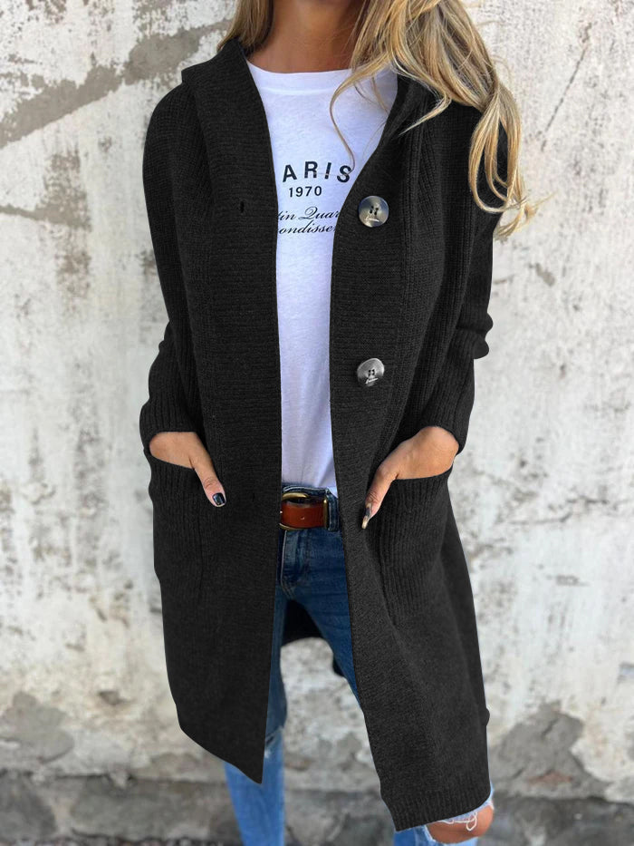 Woman wearing a long ribbed knit cardigan with large buttons and front pockets