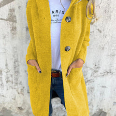 Woman wearing a long ribbed knit cardigan with large buttons and front pockets