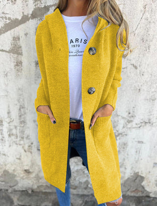Woman wearing a long ribbed knit cardigan with large buttons and front pockets