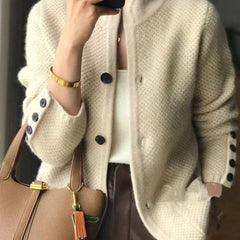 Woman wearing a soft open-front knit cardigan in camel with long sleeves and relaxed drape