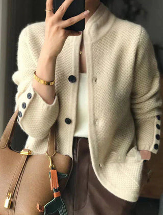 Woman wearing a soft open-front knit cardigan in camel with long sleeves and relaxed drape