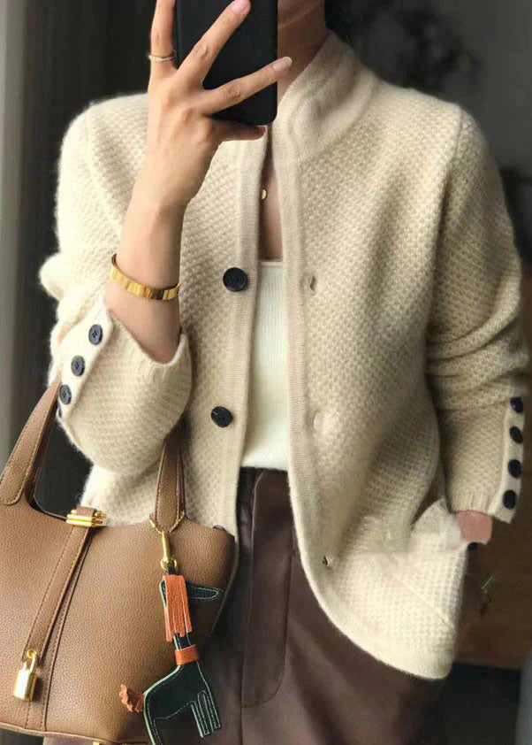 Woman wearing a soft open-front knit cardigan in camel with long sleeves and relaxed drape