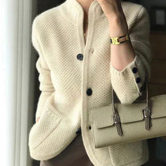 Woman wearing a soft open-front knit cardigan in camel with long sleeves and relaxed drape