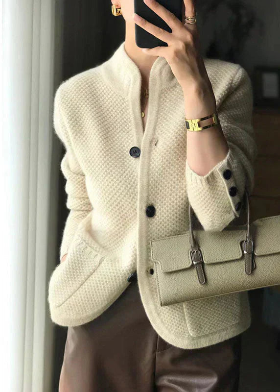 Woman wearing a soft open-front knit cardigan in camel with long sleeves and relaxed drape