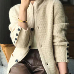 Woman wearing a soft open-front knit cardigan in camel with long sleeves and relaxed drape