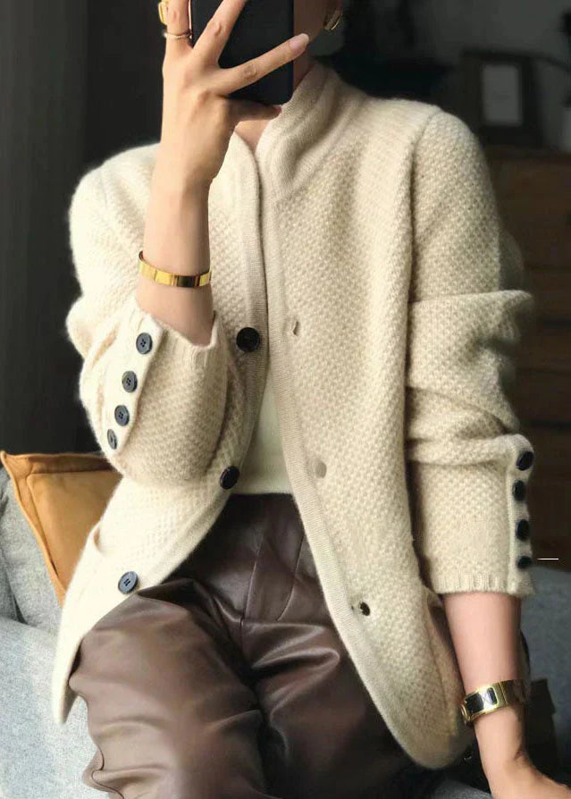 Woman wearing a soft open-front knit cardigan in camel with long sleeves and relaxed drape