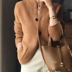 Woman wearing a soft open-front knit cardigan in camel with long sleeves and relaxed drape