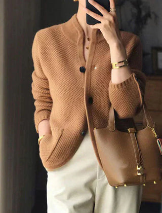 Woman wearing a soft open-front knit cardigan in camel with long sleeves and relaxed drape