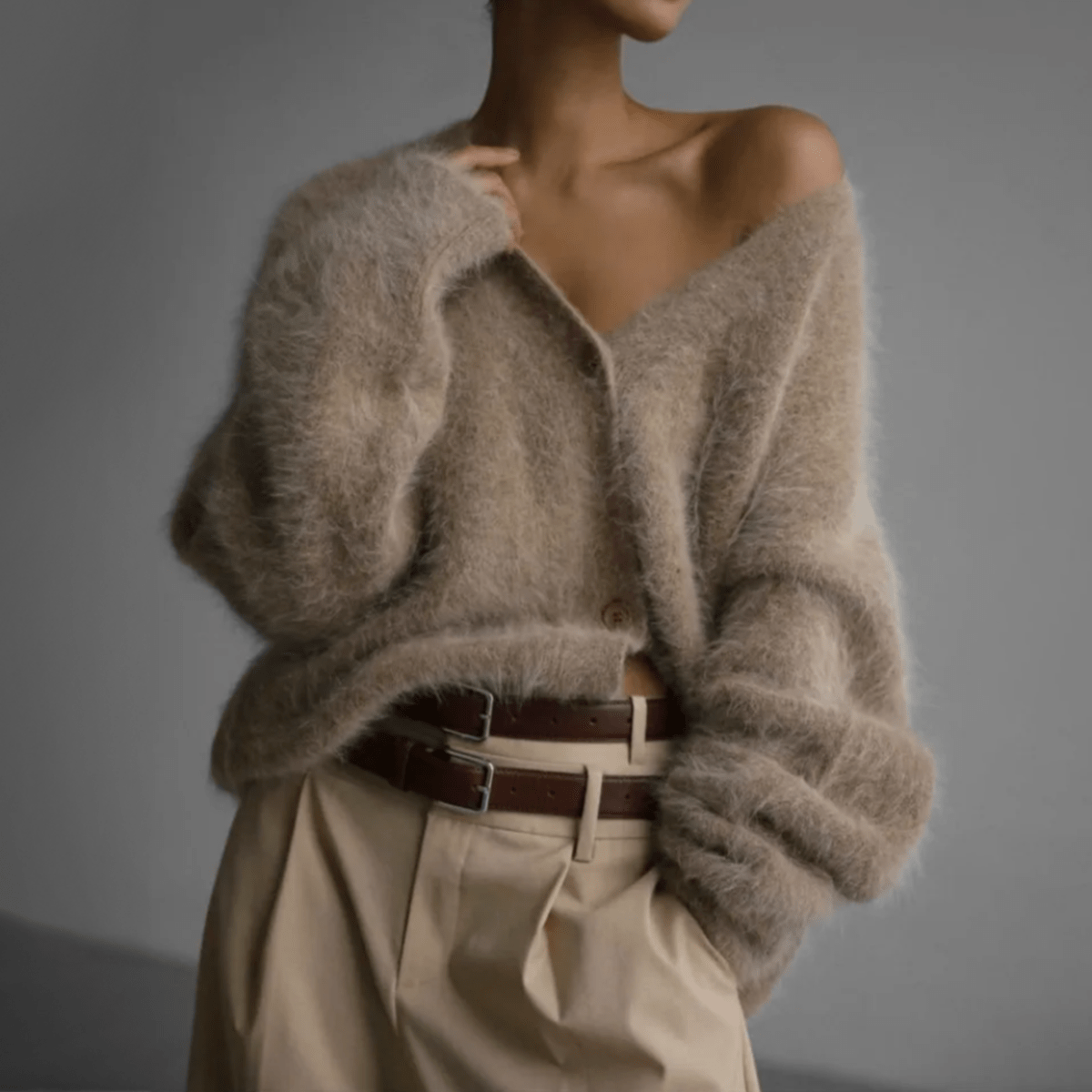 Fluffy knit cardigan with deep V-neck and oversized sleeves in neutral tones