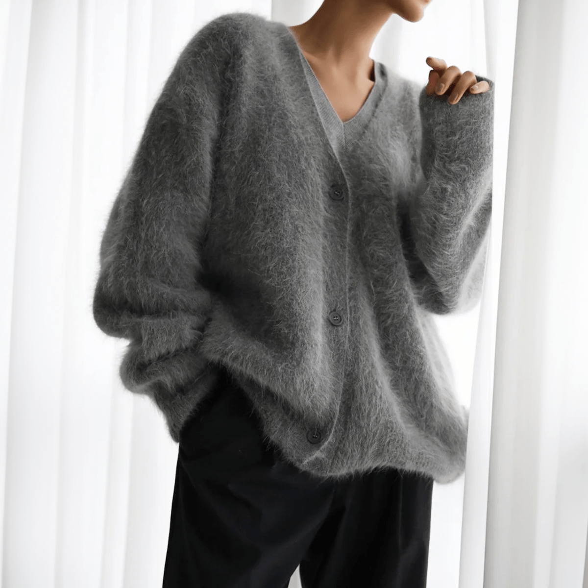 Fluffy knit cardigan with deep V-neck and oversized sleeves in neutral tones
