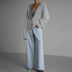 Fluffy knit cardigan with deep V-neck and oversized sleeves in neutral tones