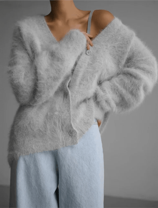 Fluffy knit cardigan with deep V-neck and oversized sleeves in neutral tones