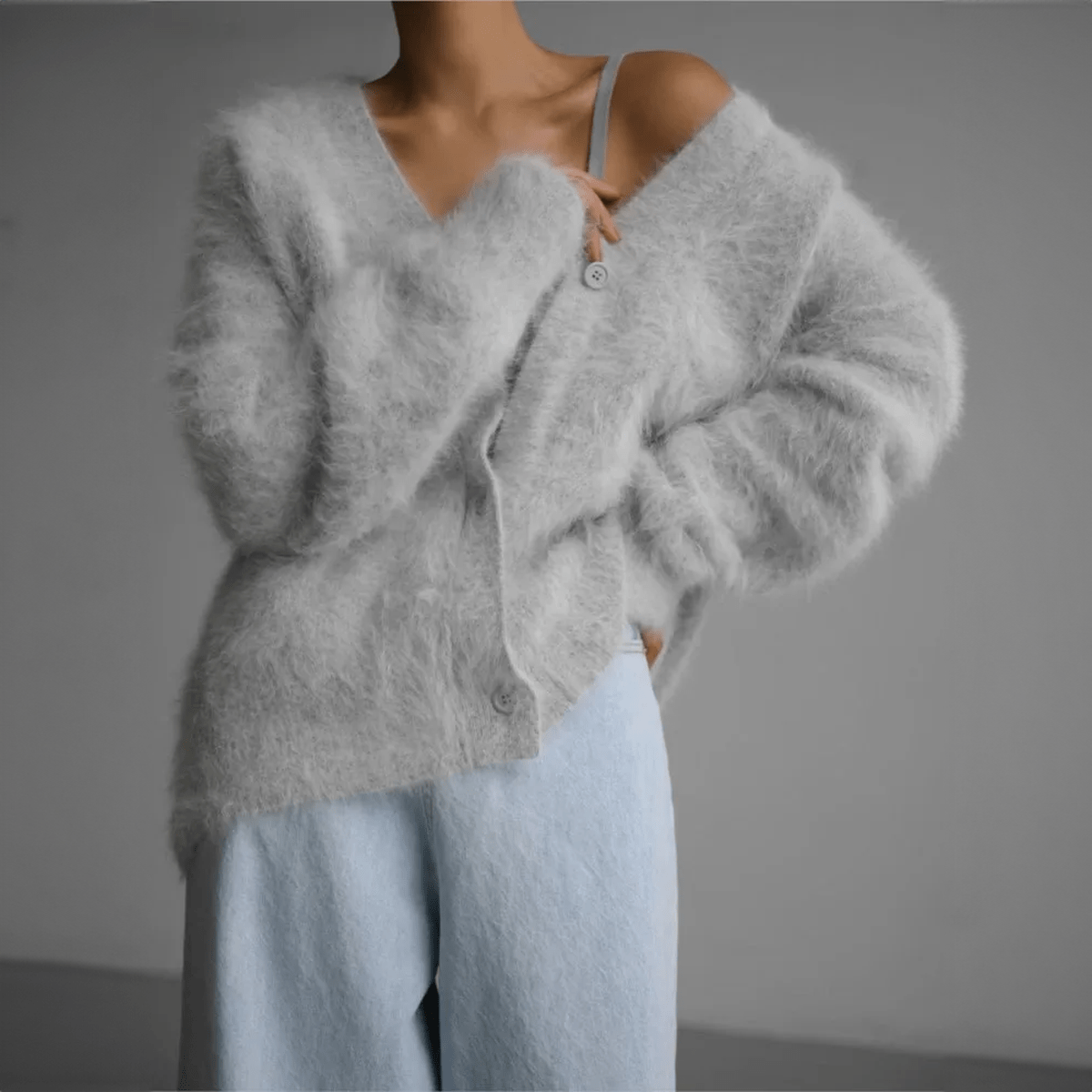 Fluffy knit cardigan with deep V-neck and oversized sleeves in neutral tones