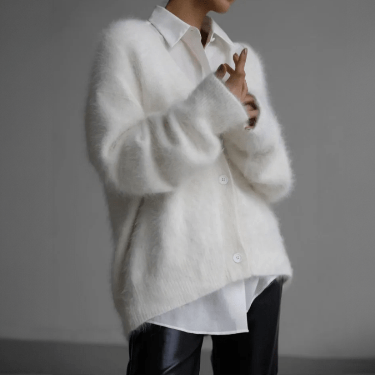 Fluffy knit cardigan with deep V-neck and oversized sleeves in neutral tones