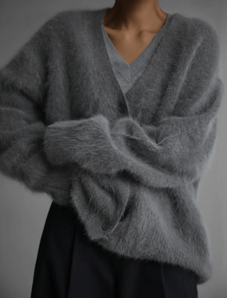 Fluffy knit cardigan with deep V-neck and oversized sleeves in neutral tones