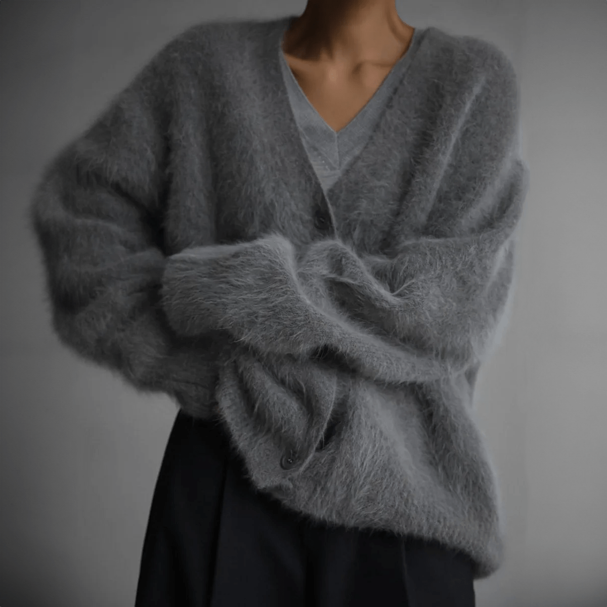 Fluffy knit cardigan with deep V-neck and oversized sleeves in neutral tones