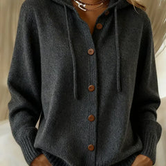 Woman wearing a soft button-front cardigan hoodie with drawstring hood and ribbed cuffs