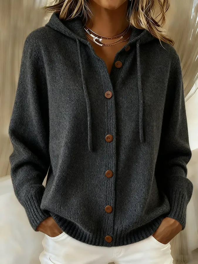 Woman wearing a soft button-front cardigan hoodie with drawstring hood and ribbed cuffs