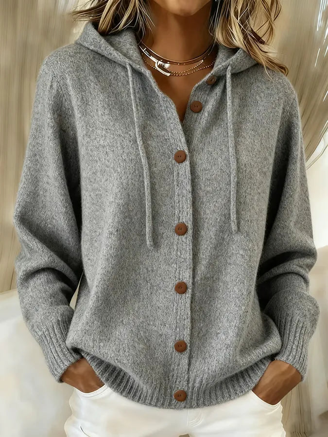 Woman wearing a soft hooded button-up cardigan with drawstring hood and ribbed cuffs