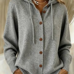Woman wearing a soft button-front cardigan hoodie with drawstring hood and ribbed cuffs