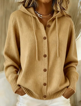 Woman wearing a soft button-front cardigan hoodie with drawstring hood and ribbed cuffs
