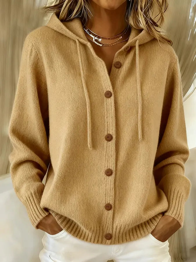 Woman wearing a soft hooded button-up cardigan with drawstring hood and ribbed cuffs
