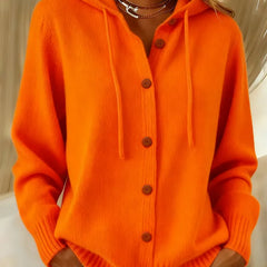 Woman wearing a soft button-front cardigan hoodie with drawstring hood and ribbed cuffs