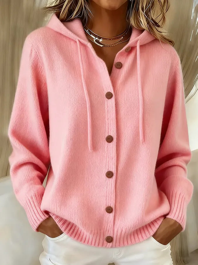 Woman wearing a soft button-front cardigan hoodie with drawstring hood and ribbed cuffs