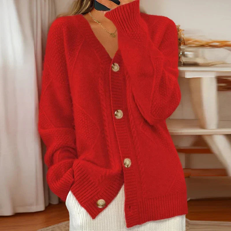 Cable knit button-front cardigan with long sleeves in soft neutral tones