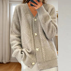 Cable knit button-front cardigan with long sleeves in soft neutral tones