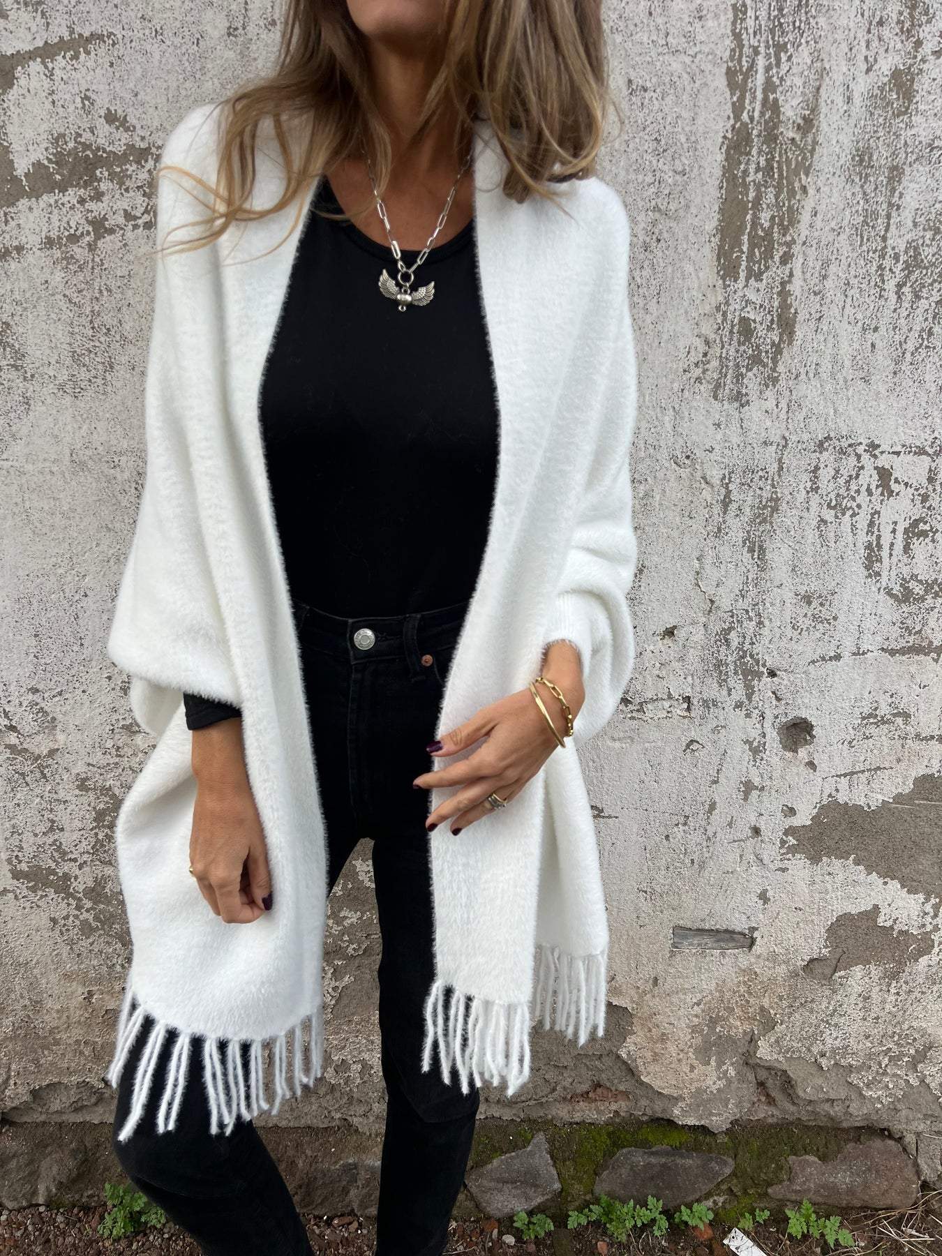 Women's long fringed knit cardigan with plush texture and draping silhouette