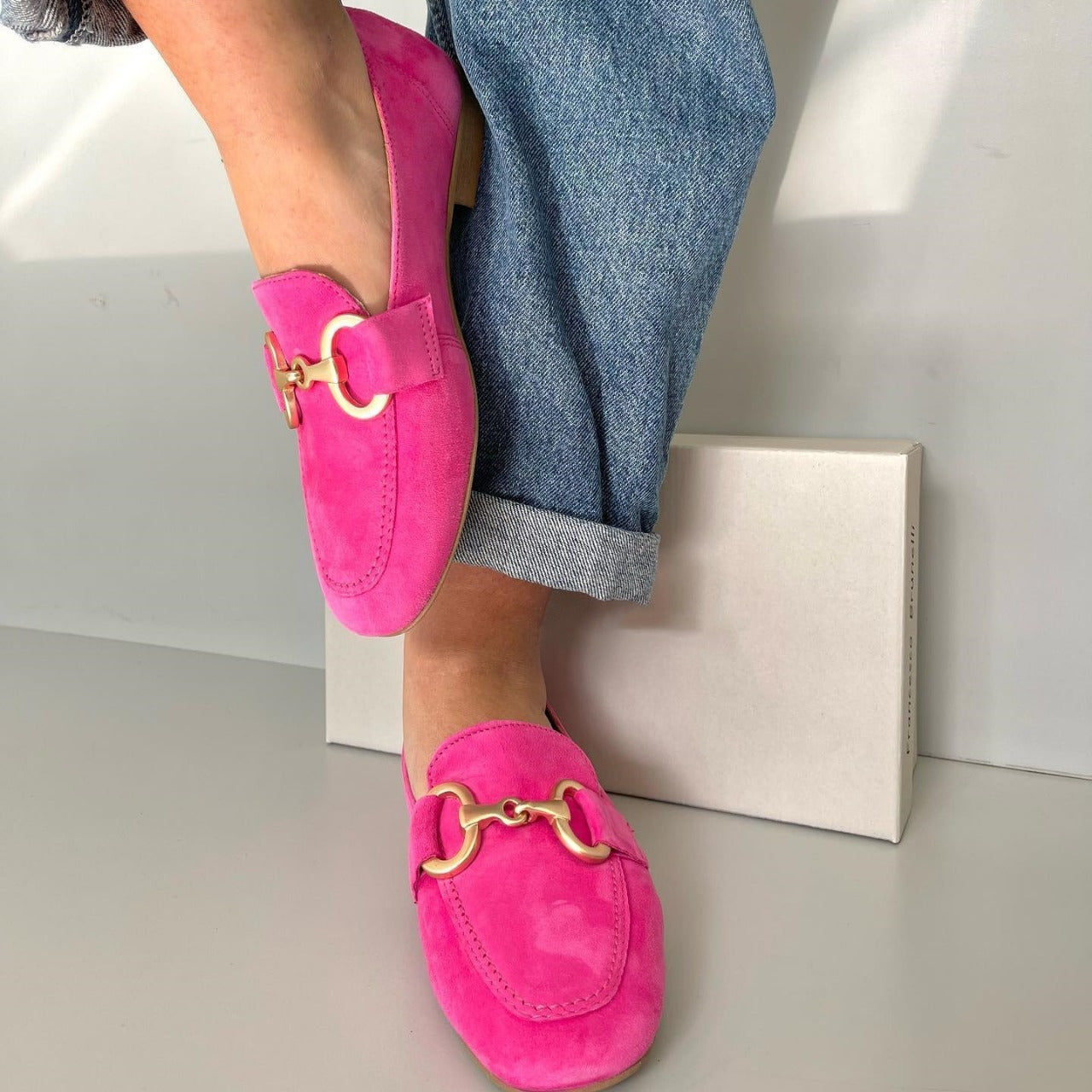 Pink loafers with a gold detail, styled for casual-chic everyday wear