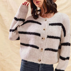 White striped button-down knit cardigan with long sleeves shown on a woman