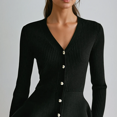 Black ribbed peplum knit top with metallic button detailing and fitted waist