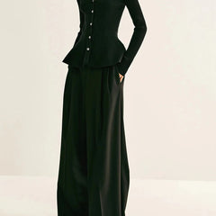 Black ribbed peplum knit top with metallic button detailing and fitted waist