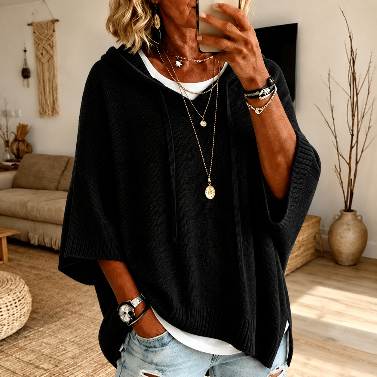 Black hooded poncho sweater with loose knit and drawstring hood