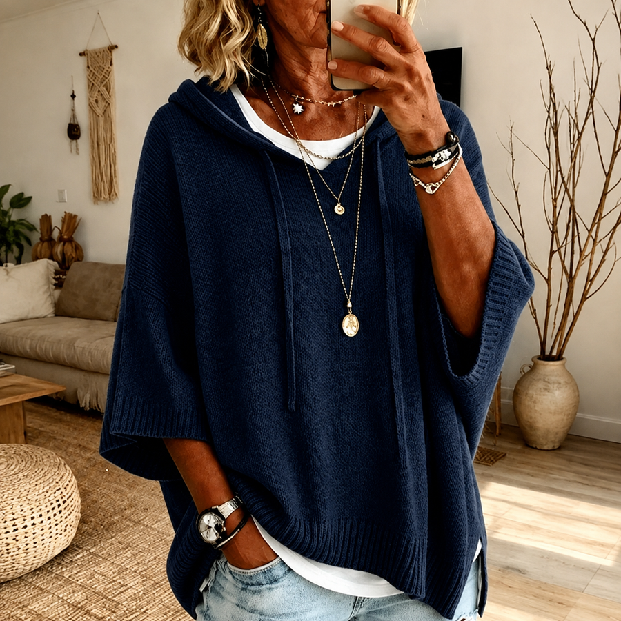 Navy blue hooded poncho sweater with drawstrings and ribbed finishes, loose relaxed fit