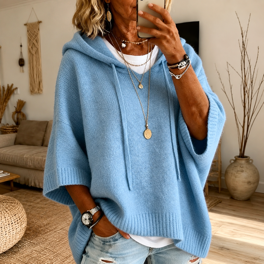 Sky blue hooded poncho sweater with loose knit and drawstring hood