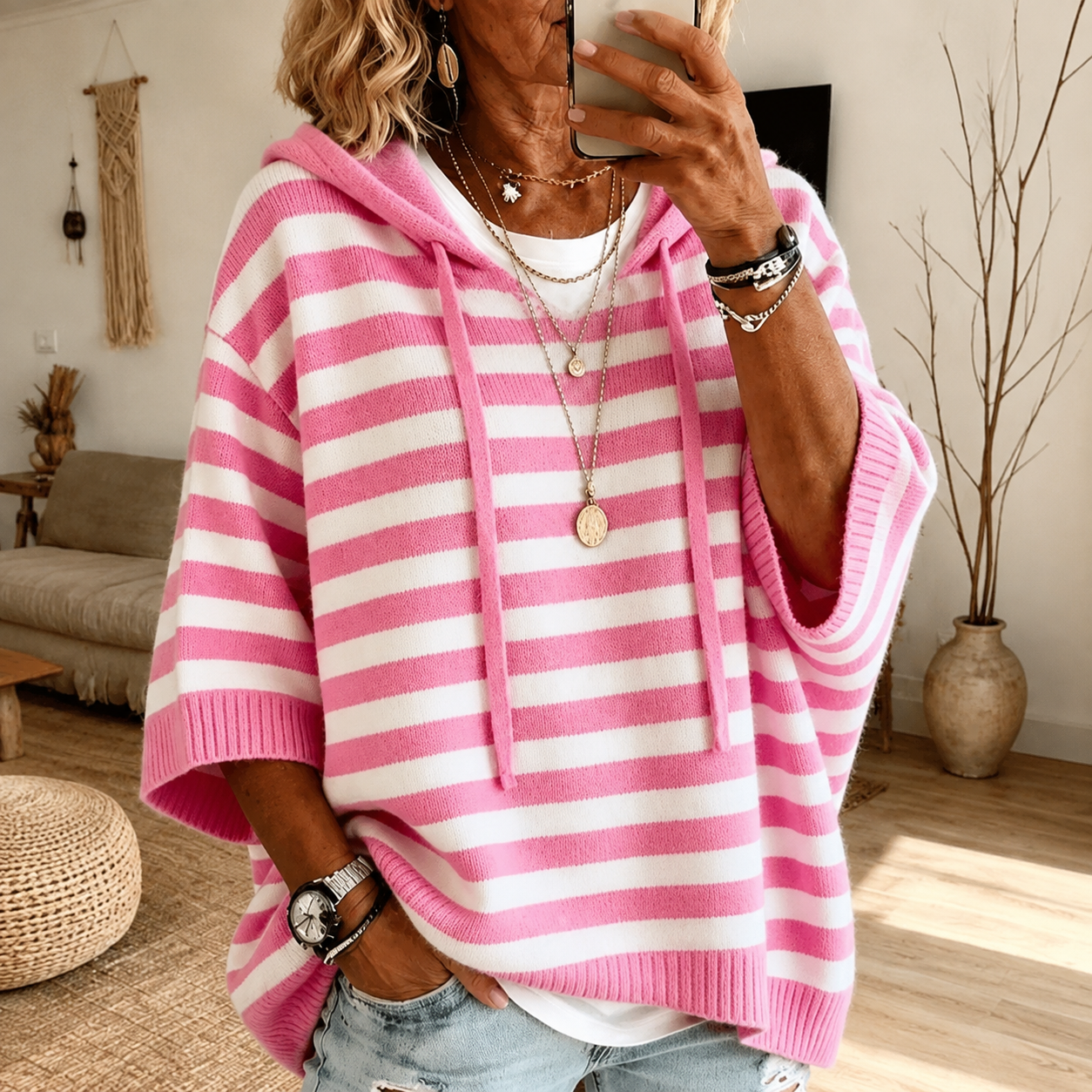 Soft pink striped hooded poncho sweater with drawstring hood and ribbed finishes