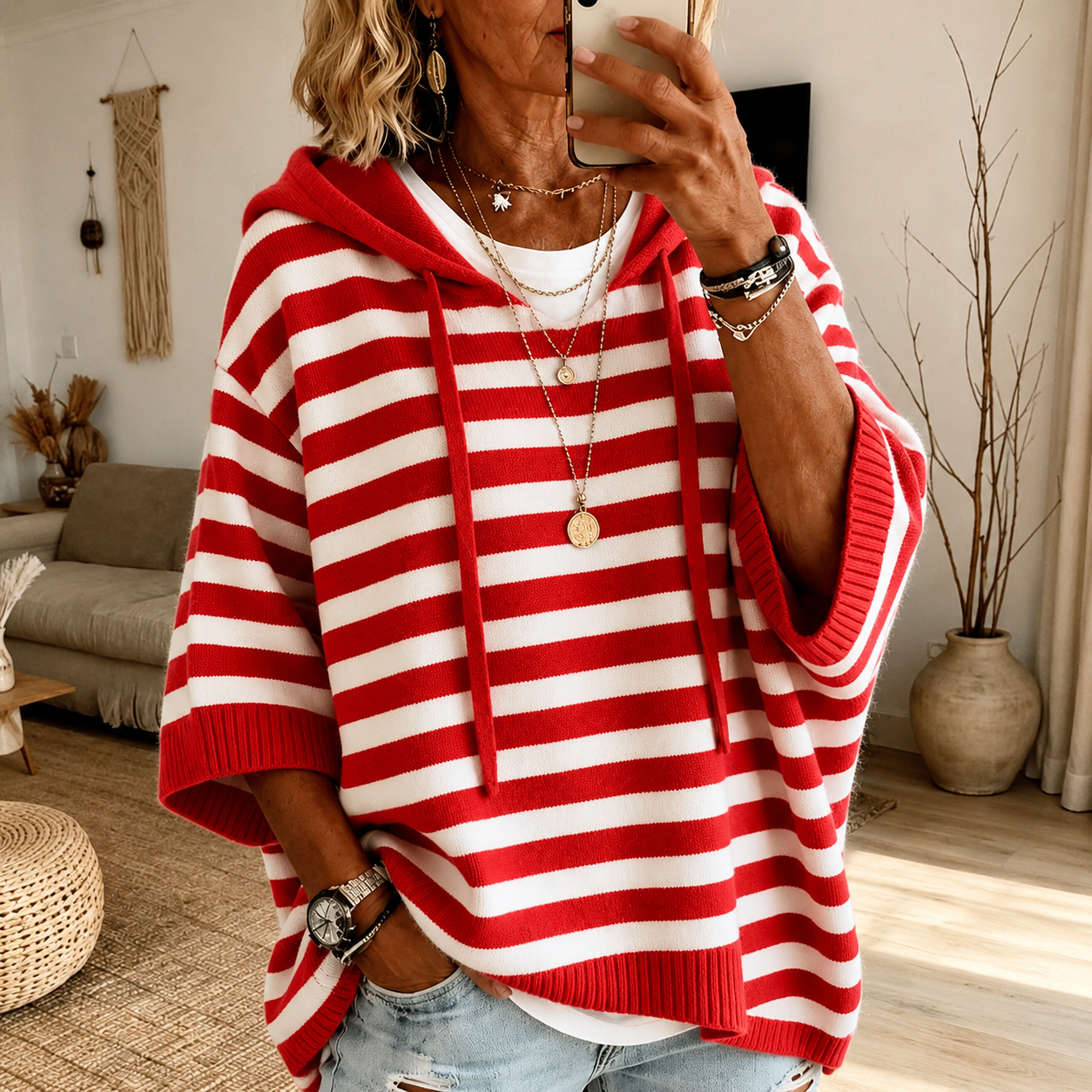 Red striped hooded poncho sweater with drawcord hood and relaxed knit fit