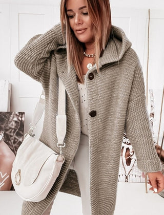Women's hooded oversized chunky knit cardigan with large buttons in a soft neutral shade