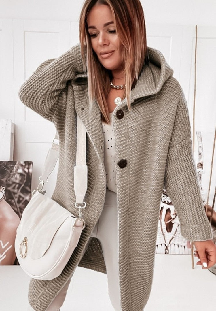 Women's hooded oversized chunky knit cardigan with large buttons in a soft neutral shade