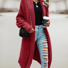 Women's hooded oversized chunky knit cardigan with large buttons in a soft neutral shade