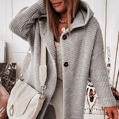 Women's hooded oversized chunky knit cardigan with large buttons in a soft neutral shade