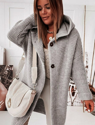 Women's hooded oversized chunky knit cardigan with large buttons in a soft neutral shade