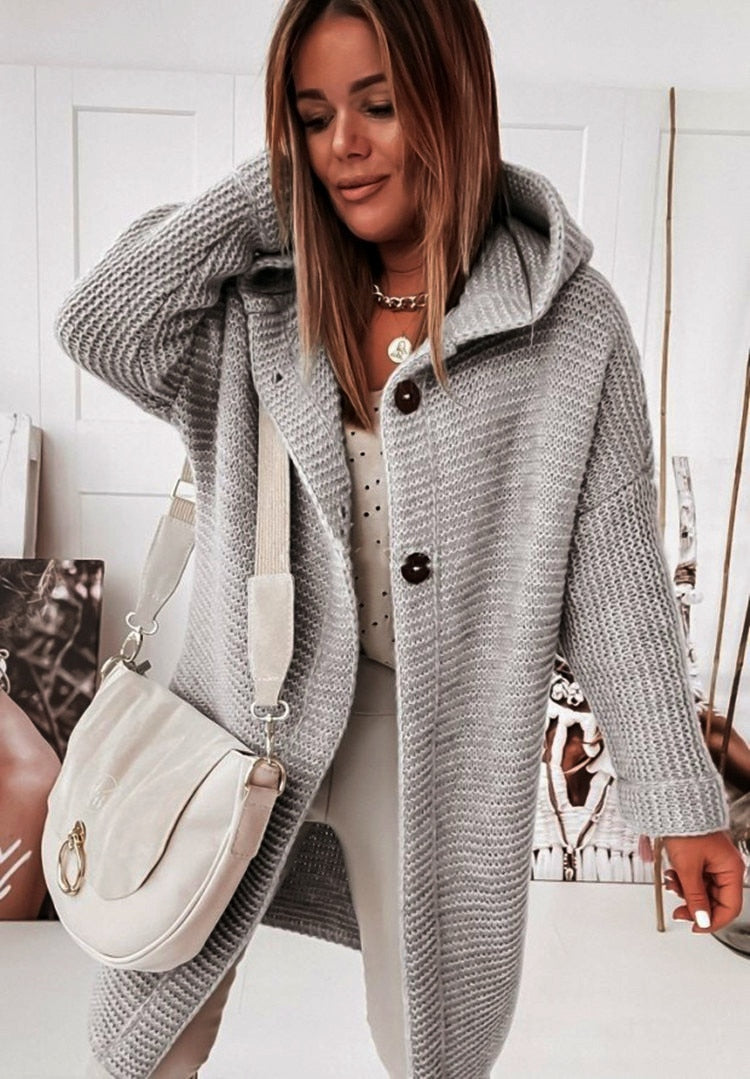 Women's hooded oversized chunky knit cardigan with large buttons in a soft neutral shade
